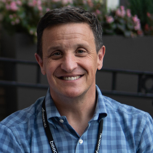 Blaine Herman, a white man with brown hair, brown eyes and wearing a blue plaid shirt.